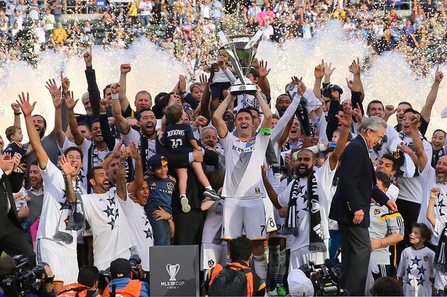 LOS ANGELES, CA - DECEMBER 07:  Captain Robbie Keane #7 of the Los Angeles Galaxy celebrates on the hoists over his head the Philip F. Anschutz Trophy after the Galaxy defeated the New England Revolution 2-1 in the 2014 MLS Cup at StubHub Center on December 7, 2014 in Los Angeles, California.  (Photo by Victor Decolongon/Getty Images)