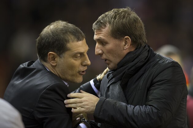 Liverpool's manager Brendan Rodgers, right, greets Besiktas manager Slaven Bilic before the Europa League Round of 32 soccer match between Liverpool and Besiktas at Anfield Stadium in Liverpool, England, Thursday, Feb. 19, 2015. (AP Photo/Jon Super)