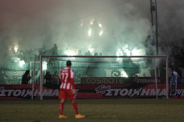 Panathinaiko’s fans hold flares as they celebrate a goal against Olympiakos during their Greek Super League soccer match at the Apostolos Nikolaides stadium in Athens, Sunday, Feb. 22, 2015. (AP Photo/Yorgos Karahalis)
