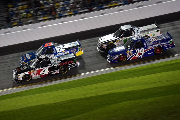 DAYTONA BEACH, FL - FEBRUARY 20:  Erik Jones, driver of the #4 Toyota Toyota, Spencer Gallagher, driver of the #23 Allegiant Travel Chevrolet, Austin Theriault, driver of the #29 Cooper Standard Careers for Veterans Ford, and Daniel Hemric, driver of the #14 California Clean Power Chevrolet, race during the NASCAR Camping World Truck Series NextEra Energy Resources 250 at Daytona International Speedway on February 20, 2015 in Daytona Beach, Florida.  (Photo by Robert Laberge/Getty Images)