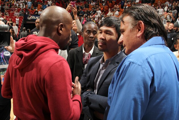 MIAMI, FL - JANUARY 27:  Boxers, Manny Pacquiao and Floyd Mayweather Jr talk before the game between the Milwaukee Bucks and Miami Heat on January 27, 2015 at American Airlines Arena in Miami, Florida. NOTE TO USER: User expressly acknowledges and agrees that, by downloading and or using this Photograph, user is consenting to the terms and conditions of the Getty Images License Agreement. Mandatory Copyright Notice: Copyright 2015 NBAE (Photo by Issac Baldizon/NBAE via Getty Images)