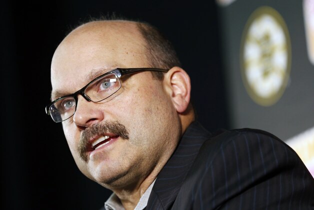 Boston Bruins general manager Peter Chiarelli talks to reporters during a news conference before a preseason NHL hockey game against the Detroit Red Wings in Boston, Saturday, Oct. 4, 2014. The Bruins announced the trade of Johnny Boychuk to the New York Islanders on Saturday. (AP Photo/Michael Dwyer)