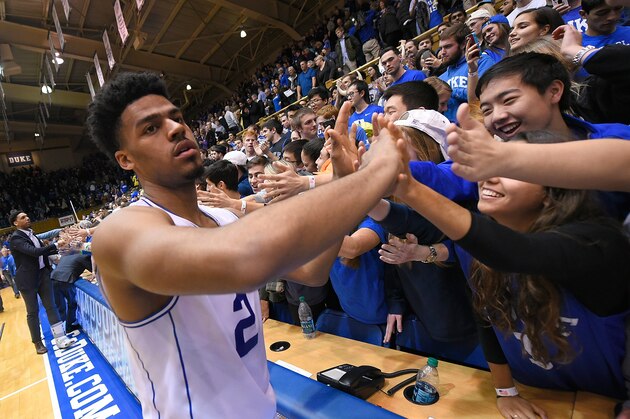 DURHAM, NC - FEBRUARY 21:  Quinn Cook #2 of the Duke Blue Devils celebrates with fans after a win against the Clemson Tigers at Cameron Indoor Stadium on February 21, 2015 in Durham, North Carolina. Duke won 78-56.  (Photo by Grant Halverson/Getty Images)