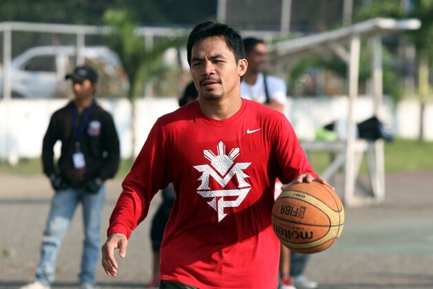 GENERAL SANTOS, PHILIPPINES - SEPTEMBER 28:  Manny Pacquiao dribbles as he plays basketball after his  training session at Calumpang Sports Complex on September 28, 2012 in General Santos, Philippines. Pacquiao will take on Mexican Juan Manual Marquez on December 8th, 2012 in Las Vegas.  (Photo by Jeoffrey Maitem/Getty Images)