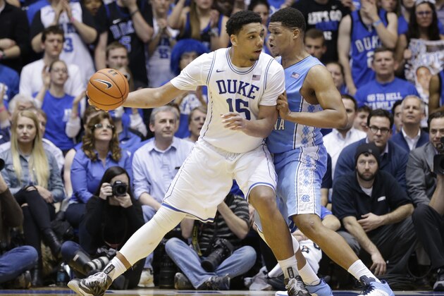 Duke's Jahlil Okafor (15) is guarded by North Carolina's Kennedy Meeks during the second half of an NCAA college basketball game in Durham, N.C., Wednesday, Feb. 18, 2015. Duke won 92-90 in overtime. (AP Photo/Gerry Broome)