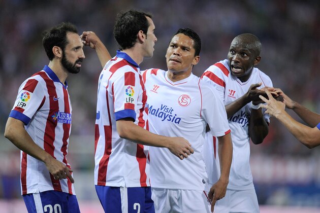 MADRID, SPAIN - SEPTEMBER 27:  Stephane Mbia (R) and Carlos Bacca of Sevilla FC argue JuanFran (L) and Diego Godinof Club Atletico de Madrid during the La Liga match between Club Atletico de Madrid and Sevilla FC at Vicente Calderon Stadium on September 27, 2014 in Madrid, Spain.  (Photo by Denis Doyle/Getty Images)