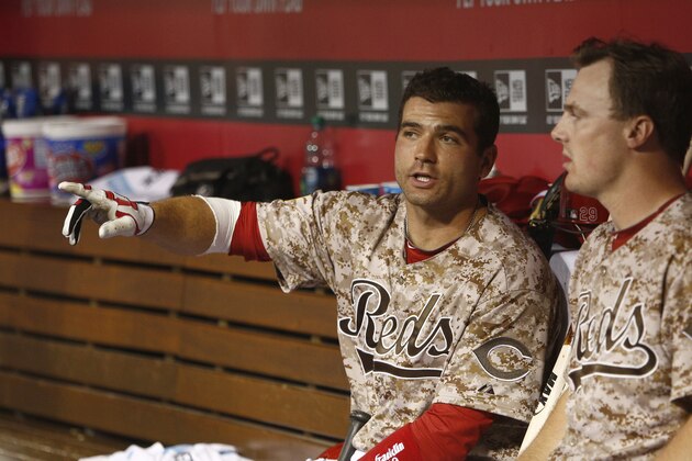 Cincinnati Reds first baseman Joey Votto, left, talks with right fielder Jay Bruce, right, during a baseball game against the Los Angeles Dodgers, Wednesday, June 11, 2014, in Cincinnati. (AP Photo/David Kohl)