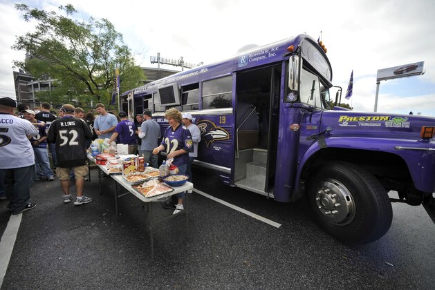 Baltimore Ravens fans hold picnic outside of a bus painted in the team colors before the NFL football game against the Cleveland Browns in Baltimore,Sunday, Sep 27, 2009. (AP Photo/Gail Burton)