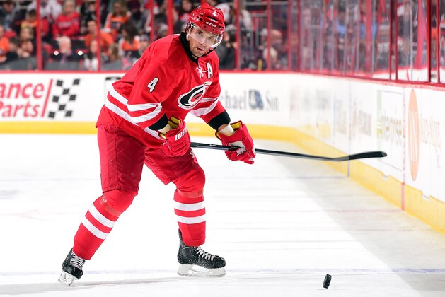 RALEIGH, NC - FEBRUARY 24: Andrej Sekera #4 of the Carolina Hurricanes looks for passing options before releasing the puck during an NHL game against the Philadelphia Flyers on February 24, 2015 at PNC Arena in Raleigh, North Carolina.  (Photo by Gregg Forwerck/NHLI via Getty Images)