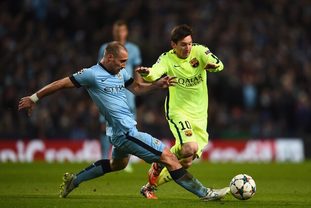 MANCHESTER, ENGLAND - FEBRUARY 24:  Pablo Zabaleta of Manchester City tackles Lionel Messi of Barcelona during the UEFA Champions League Round of 16 match between Manchester City and Barcelona at Etihad Stadium on February 24, 2015 in Manchester, United Kingdom.  (Photo by Laurence Griffiths/Getty Images)