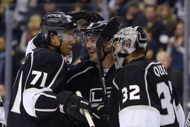 Los Angeles Kings center Jordan Nolan, left, defenseman Drew Doughty, center, and goalie Jonathan Quick celebrate after they defeated the Vancouver Canucks during in an NHL hockey game, Saturday, Nov. 9, 2013, in Los Angeles. The Kings won 5-1. (AP Photo/Mark J. Terrill)
