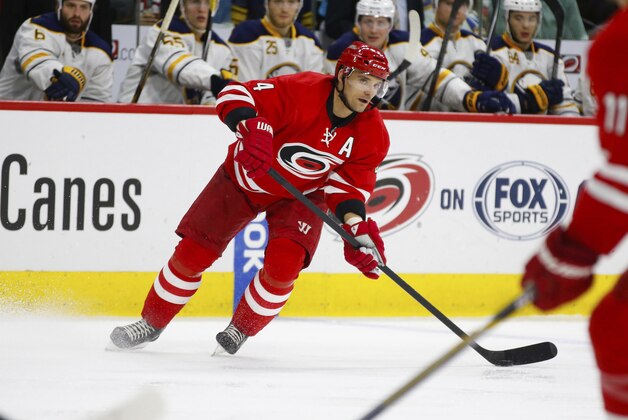 Jan 8, 2015; Raleigh, NC, USA; Carolina Hurricanes defensemen Andrej Sekera (4) skates with puck against the  Buffalo Sabres at PNC Arena. The Hurricanes defeated the Sabres 5-2. Mandatory Credit: James Guillory-USA TODAY Sports
