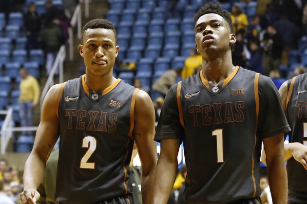 Feb 24, 2015; Morgantown, WV, USA; Texas Longhorns guard Demarcus Holland (2) and guard Isaiah Taylor (1) walk off the court after the game against the West Virginia Mountaineers at WVU Coliseum. The Mountaineers won 71-64. Mandatory Credit: Aaron Doster-USA TODAY Sports