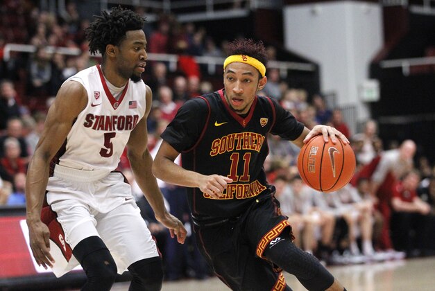 Feb 8, 2015; Stanford, CA, USA; USC Trojans guard Jordan McLaughlin (11) drives past Stanford Cardinal guard Chasson Randle (5) in the second half at Maples Pavilion. The Cardinal defeated the Trojans 70-62. Mandatory Credit: Cary Edmondson-USA TODAY Sports
