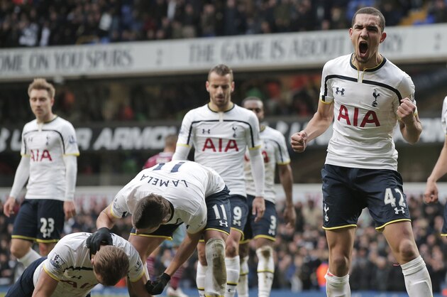 Tottenham Hotspur's Nabil Bentaleb, center, celebrates after his teammate Harry Kane, bottom left, won a penalty during an English Premier League soccer match against West Ham United at the White Hart Lane ground in London, Sunday, Feb. 22, 2015. Kane went on to score the equalizer goal for his team and the match ended 2-2 draw. (AP Photo/Lefteris Pitarakis)