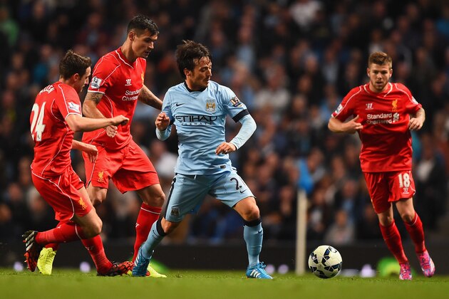 MANCHESTER, ENGLAND - AUGUST 25:  David Silva of Manchester City competes with Dejan Lovren and Joe Allen of Liverpool during the Barclays Premier League match between Manchester City and Liverpool at the Etihad Stadium on August 25, 2014 in Manchester, England.  (Photo by Laurence Griffiths/Getty Images)