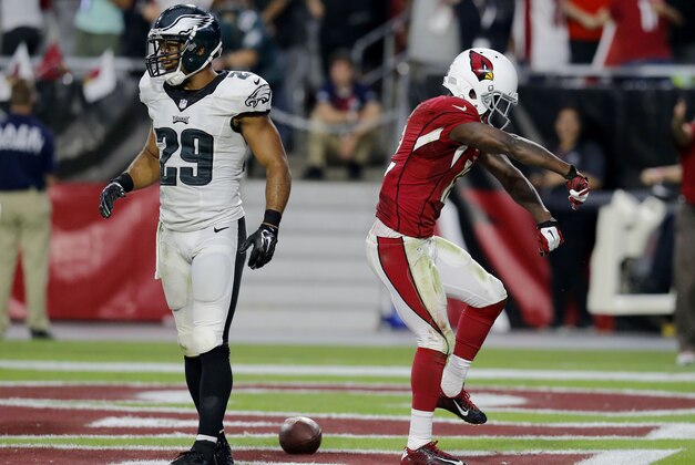 Arizona Cardinals wide receiver John Brown (12) celebrators his touchdown as Philadelphia Eagles strong safety Nate Allen (29) walks away during the second half of an NFL football game, Sunday, Oct. 26, 2014, in Glendale, Ariz. (AP Photo/Rick Scuteri)