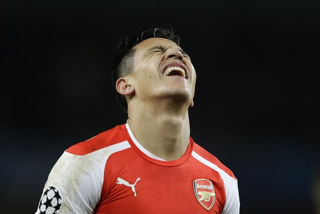 Arsenal's Alexis Sanchez grimaces during the Champions League round of 16 soccer match between Arsenal and AS Monaco at the Emirates Stadium in London, Wednesday, Feb. 25, 2015.  (AP Photo/Matt Dunham)