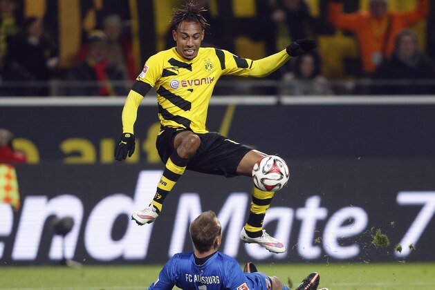 Augsburg's goalkeeper Alexander Manninger from Austria,down, and Dortmund's Pierre-Emerick Aubameyang from Gabun challenge for the ball during the German first division Bundesliga soccer match between BvB Borussia Dortmund and FC Augsburg in Dortmund, Germany, Wednesday, Feb. 4, 2015. (AP Photo/Frank Augstein)