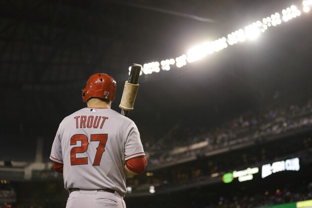 Los Angeles Angels' Mike Trout stands under the lights of Safeco Field as he waits for an at-bat duirng a baseball game against the Seattle Mariners, Friday, Sept. 26, 2014, in Seattle. (AP Photo/Ted S. Warren)