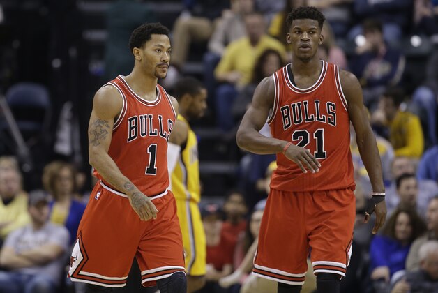 Chicago Bulls' Derrick Rose (1) and Jimmy Butler (21) talk during the first half of an NBA basketball game against the Indiana Pacers Monday, Dec. 29, 2014, in Indianapolis. (AP Photo/Darron Cummings)