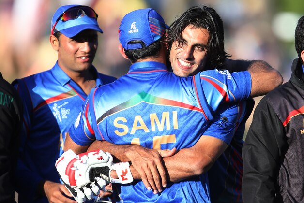 Afghanistan’s Shapoor Zadran, right, embraces teammate  Samiullah Shenwari as he celebrates his team's Cricket World Cup Pool A win over Scotland in Dunedin, New Zealand, Thursday, Feb. 26, 2015. (AP Photo/Dianne Manson)
