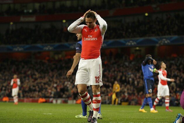 Arsenal's Olivier Giroud reacts after missing a chance in the Champions League round of 16 soccer match between Arsenal and AS Monaco at the Emirates Stadium in London, Wednesday, Feb. 25, 2015.  Monaco won the match 3-1.  (AP Photo/Matt Dunham)