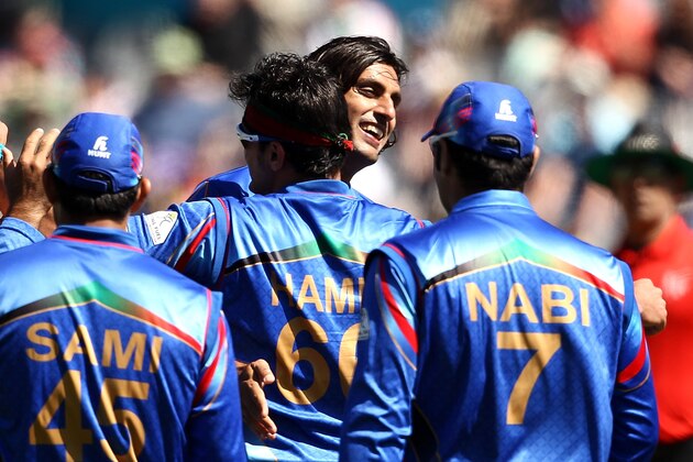 DUNEDIN, NEW ZEALAND - FEBRUARY 26: Shapoor Zadran (C) of Afghanistan celebrates with team mates during the 2015 ICC Cricket World Cup match between Afghanistan and Scotland at University Oval on February 26, 2015 in Dunedin, New Zealand.  (Photo by Martin Hunter/Getty Images)