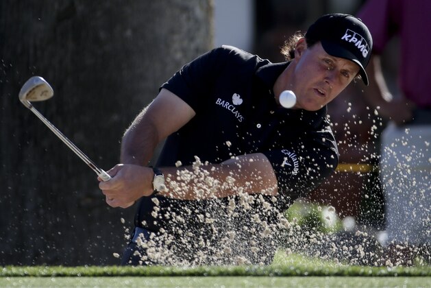 Phil Mickelson watches his bunker shot on the fourth hole during the first round of the Humana Challenge golf tournament at the La Quinta Country Club on Thursday, Jan. 22, 2015 in La Quinta, Calif. (AP Photo/Chris Carlson)