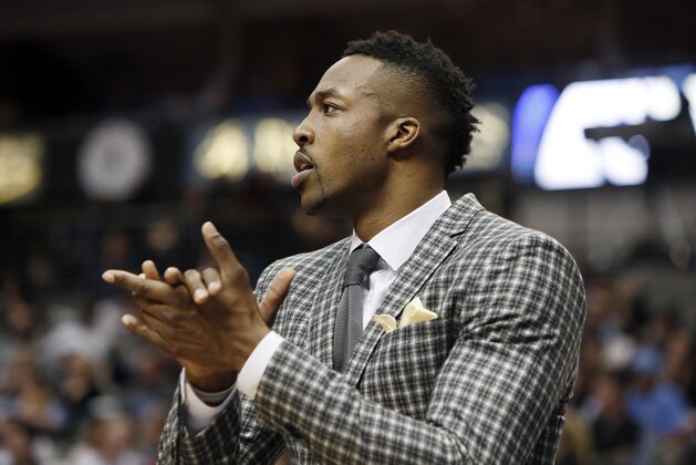 Houston Rockets center Dwight Howard looks on from the bench during the second half of an NBA basketball game against the Dallas Mavericks, Friday, Feb. 20, 2015, in Dallas. Dallas won 111-100. (AP Photo/Brandon Wade)