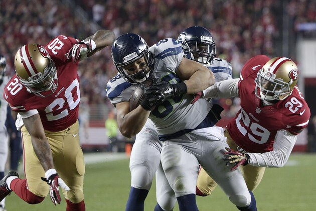 Seattle Seahawks tight end Tony Moeaki (88) is tackled by San Francisco 49ers defensive back Perrish Cox (20) and defensive back Chris Culliver (29) during the second quarter of an NFL football game in Santa Clara, Calif., Thursday, Nov. 27, 2014. (AP Photo/Marcio Jose Sanchez)