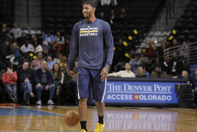 Injured Indiana Pacers guard Paul George jokes with teammates while shooting before facing the Denver Nuggets in an NBA basketball game Saturday, Dec. 20, 2014, in Denver. George has been sidelined since July when he fractured both his tibia and fibula during a Team USA basketball scrimmage in Las Vegas. (AP Photo/David Zalubowski)