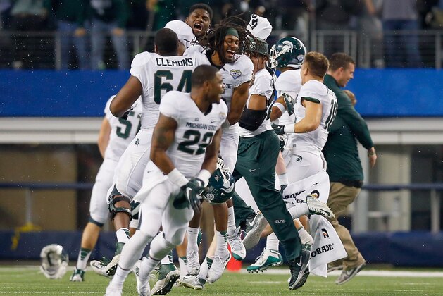 ARLINGTON, TX - JANUARY 01:  The Michigan State Spartans celebrate after beating the Baylor Bears 42-41 during the Goodyear Cotton Bowl Classic at AT&T Stadium on January 1, 2015 in Arlington, Texas.  (Photo by Tom Pennington/Getty Images)