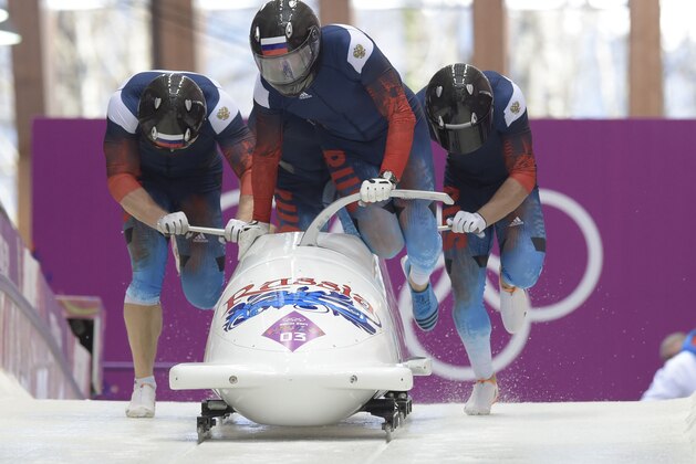 Feb 23, 2014; Krasnaya Polyana, RUSSIA; Team RUS 1 piloted by Alexander Zubkov and teammates Alexey Negodaylo, Dmitry Trunenkov and Alexey Voevoda on the final run in the 4-man bobsled during the Sochi 2014 Olympic Winter Games at Sanki Sliding Center. Mandatory Credit: John David Mercer-USA TODAY Sports