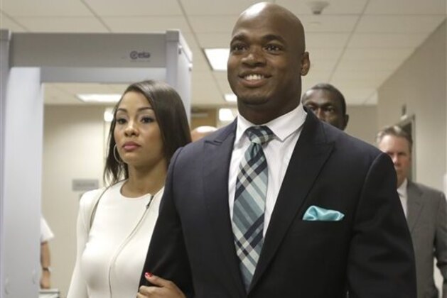 FILE - In this  Nov. 4, 2014, file photo, Minnesota Vikings running back Adrian Peterson leaves the courthouse with his wife Ashley Brown Peterson in Conroe, Texas. A federal judge has cleared the way for Peterson to be reinstated. U.S. District Judge David Doty issued his order Thursday, Feb. 26, 2015, less than three weeks after hearing oral arguments. (AP Photo/Pat Sullivan, File)