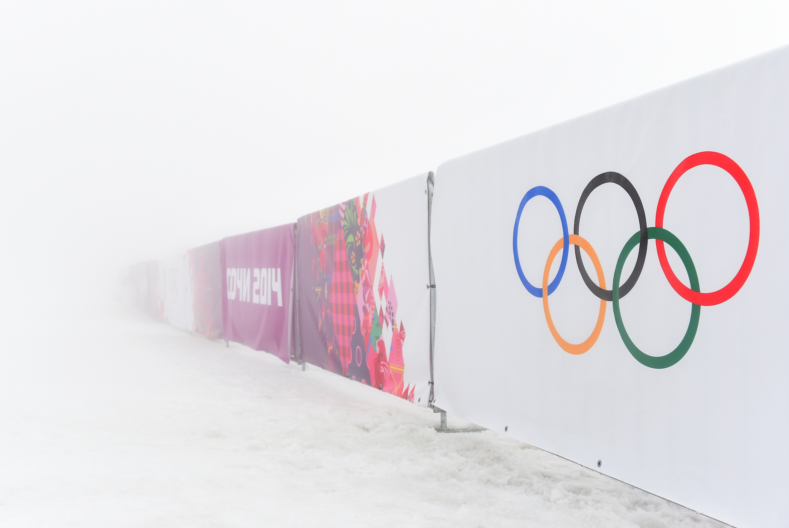 SOCHI, RUSSIA - FEBRUARY 17:  A general view of barriers displaying the Olympic rings in fog during day ten of the Sochi 2014 Winter Olympics at Laura Cross-country Ski & Biathlon Center on February 17, 2014 in Sochi, Russia.  (Photo by Harry How/Getty Images)