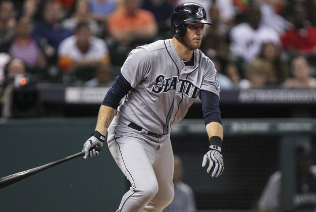 Sep 19, 2014; Houston, TX, USA; Seattle Mariners right fielder Michael Saunders (55) reaches on an error during the fourth inning against the Houston Astros at Minute Maid Park. Mandatory Credit: Troy Taormina-USA TODAY Sports