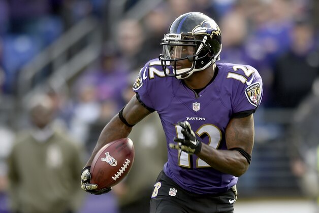Baltimore Ravens wide receiver Jacoby Jones (12) carries the ball during the first half of an NFL football game against the Tennessee Titans in Baltimore, Sunday, Nov. 9, 2014. (AP Photo/Gail Burton)