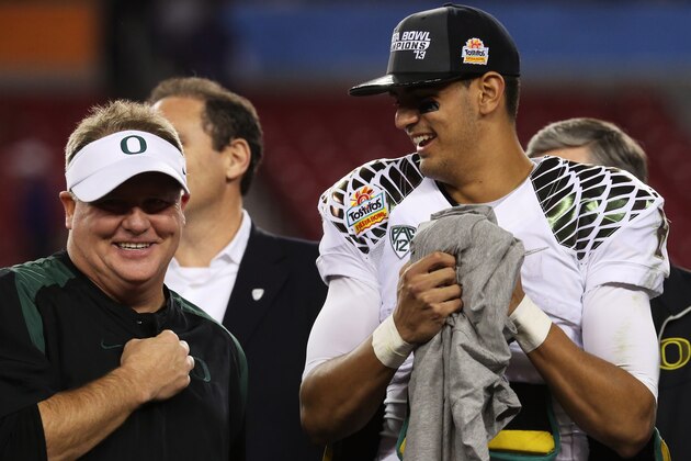 GLENDALE, AZ - JANUARY 03:  Head coach Chip Kelly celebrates with Marcus Mariota #8 of the Oregon Ducks after their 35 to 17 win over the Kansas State Wildcats in the Tostitos Fiesta Bowl at University of Phoenix Stadium on January 3, 2013 in Glendale, Arizona.  (Photo by Stephen Dunn/Getty Images)