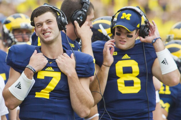 Michigan quarterback Shane Morris (7), wearing a headset on the sideline, reacts to a replay on the stadium scoreboard in the third quarter of an NCAA college football game against Appalachian State in Ann Arbor, Mich., Saturday, Aug. 30, 2014. Michigan won 52-14. (AP Photo/Tony Ding)