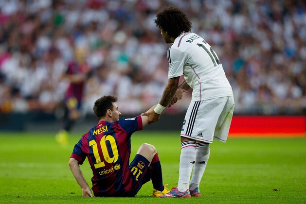 MADRID, SPAIN - OCTOBER 25:  Marcelo of Real Madrid CF helps Lionel Messi of Barcelona to his feet during the La Liga match between Real Madrid CF and FC Barcelona at Estadio Santiago Bernabeu on October 25, 2014 in Madrid, Spain.  (Photo by Gonzalo Arroyo Moreno/Getty Images)