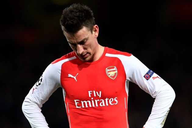 LONDON, ENGLAND - FEBRUARY 25:  A dejected Laurent Koscielny of Arsenal reacts following his team's 3-1 defeat during the UEFA Champions League round of 16, first leg match between Arsenal and Monaco at The Emirates Stadium on February 25, 2015 in London, United Kingdom.  (Photo by Clive Mason/Getty Images)