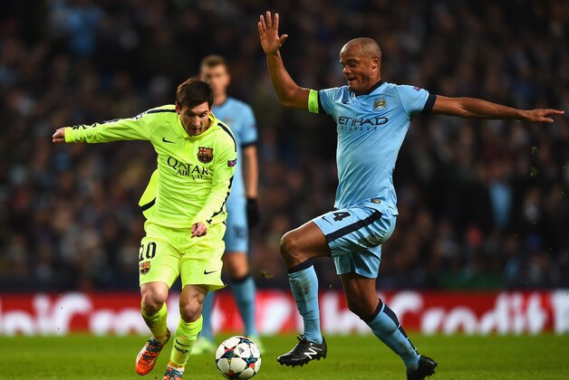 MANCHESTER, ENGLAND - FEBRUARY 24:  Vincent Kompany of Manchester City challenges Lionel Messi of Barcelona during the UEFA Champions League Round of 16 match between Manchester City and Barcelona at Etihad Stadium on February 24, 2015 in Manchester, United Kingdom.  (Photo by Laurence Griffiths/Getty Images)
