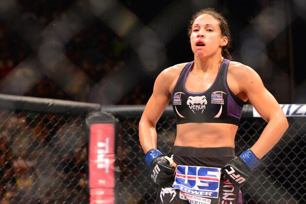 Feb 22, 2015; Porto Alegre, Brazil;  Marion Reneau (blue gloves) reacts after defeating Jessica Andrade (red gloves) during UFC Fight Night at Ginasio do Gigantinho. Mandatory Credit: Jason da Silva-USA TODAY Sports