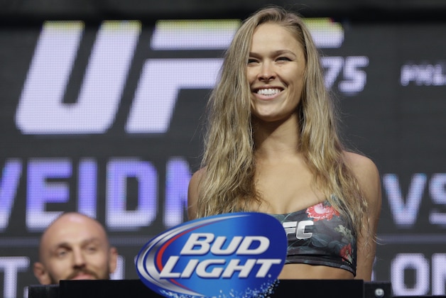 FILE - In this July 4, 2014, file photo, Ronda Rousey stands on the scale during a weigh-in for the UFC 175 mixed martial arts event at the Mandalay Bay in Las Vegas. Rousey has dominated every challenger in her two-year reign as the UFC's only women's bantamweight champion. Cat Zingano still believes she has a legitimate shot at Rousey's belt in UFC 184 on Saturday, Feb. 28, 2015, in Los Angeles. (AP Photo/John Locher, File)