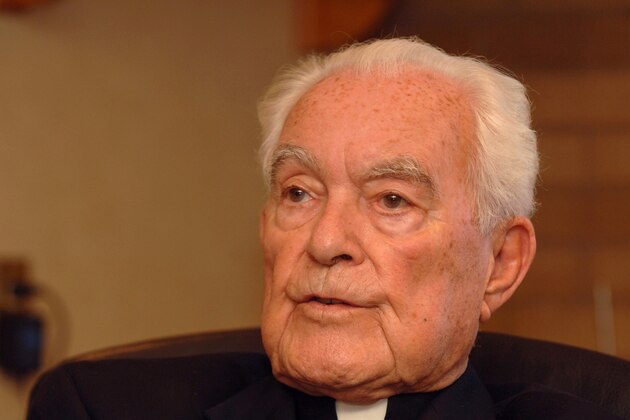 FILE - The Rev. Theodore Hesburgh, C.S.C, president emeritus of the University of Notre Dame, talks about his experiences over 90 years of life at his desk in the Hesburgh Library on the campus of the University of Notre Dame in South Bend, Ind., in this Sept. 24, 2007 file photo. The priest who transformed the University of Notre Dame into an academic power during his 35 years in charge while also serving as an adviser to popes and presidents died Thursday night Feb. 26, 2015 at age 97 according to University spokesman Paul Browne. (AP Photo/Joe Raymond, File)