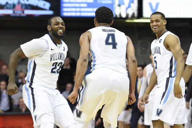 Feb 24, 2015; Villanova, PA, USA; Villanova Wildcats guard Darrun Hilliard II (4) reacts after making a three-point shot with forward JayVaughn Pinkston (22) and guard Phil Booth (5)  during the second half against the Providence Friars at The Pavilion. The Wildcats defeated the Friars, 89-61. Mandatory Credit: Eric Hartline-USA TODAY Sports