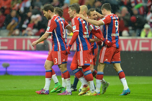 Bayern's players celebrate after scoring during the soccer match between FC Bayern Munich and 1. FC Cologne in the Allianz Arena in Munich, Germany, Friday, Feb. 27, 2015. (AP Photo/Kerstin Joensson)