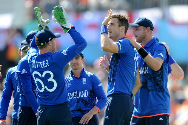 England's Steven Finn, centre, is congratulated by teammates Jos Butler, left, and Stuart Broad after dismissing Scotland's Matt Machan during their Cricket World Cup match in Christchurch, New Zealand, Monday, Feb. 23, 2015. (AP Photo Ross Setford)