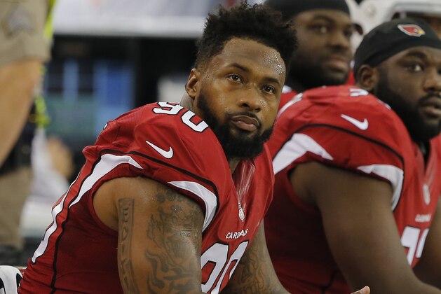 FILE - In this Aug. 9, 2014, file photo, Arizona Cardinals' Darnell Dockett sits on the sideline during the first quarter of an NFL football game in Glendale, Ariz. The Cardinals have released defensive tackle Dockett, allowing the three-time Pro Bowl lineman to test the free agency market. (AP Photo/Rick Scuteri, File)